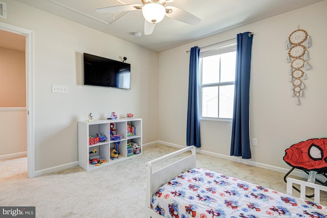 carpeted bedroom featuring attic access, baseboards, visible vents, and ceiling fan