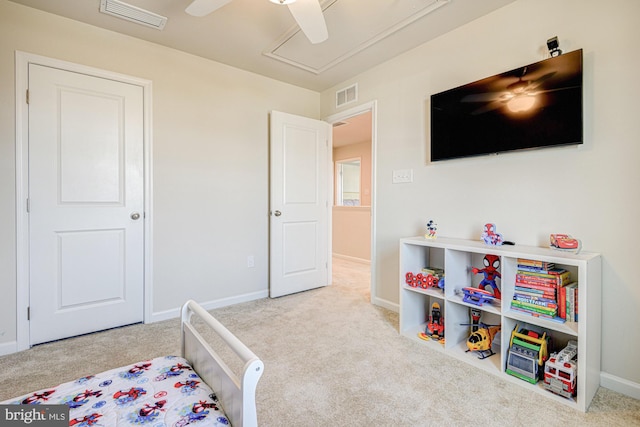 carpeted bedroom with baseboards, visible vents, and ceiling fan