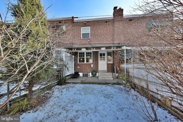 snow covered property with central air condition unit