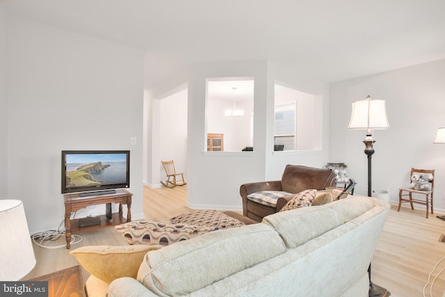 living room featuring a chandelier and light hardwood / wood-style floors