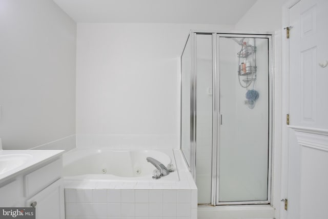 bathroom featuring vanity and shower with separate bathtub