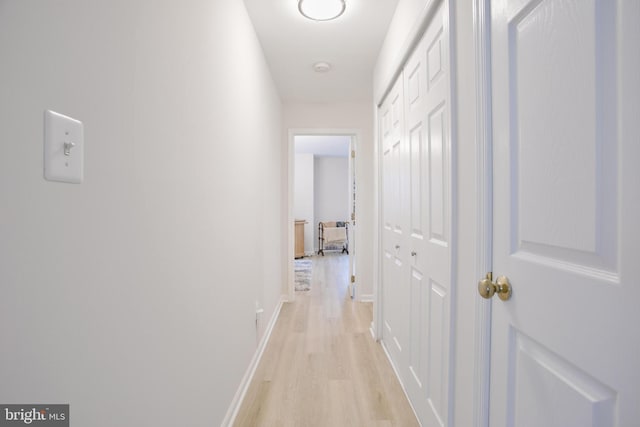 corridor with light hardwood / wood-style flooring