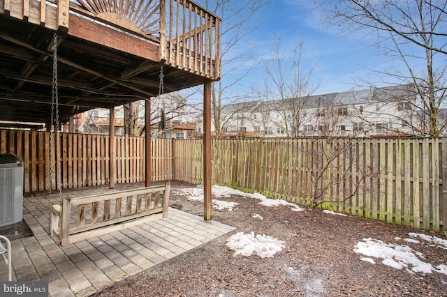 snow covered patio with a deck and central air condition unit