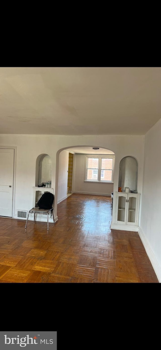 interior space featuring dark parquet flooring