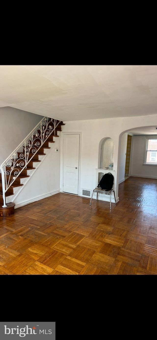 interior space featuring dark parquet flooring