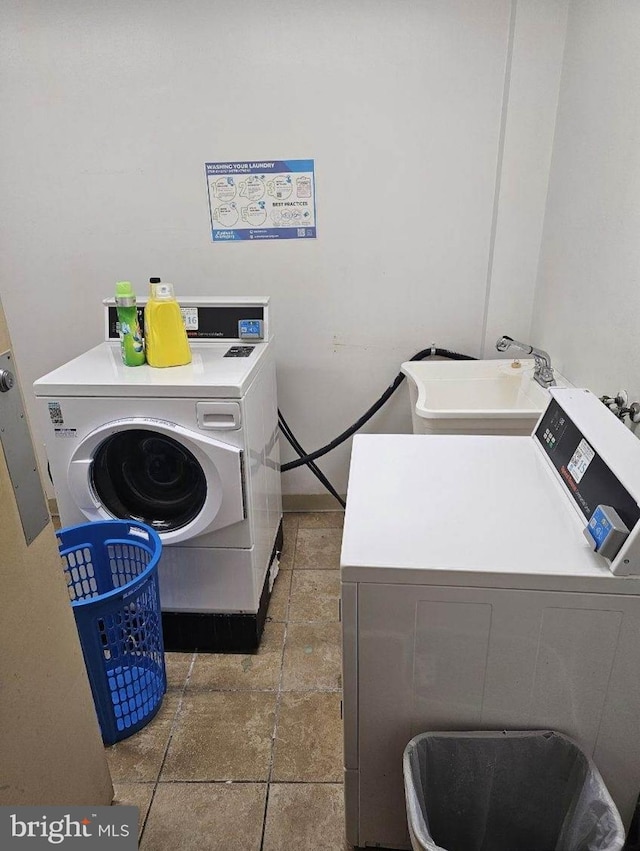 laundry room featuring sink and washing machine and clothes dryer