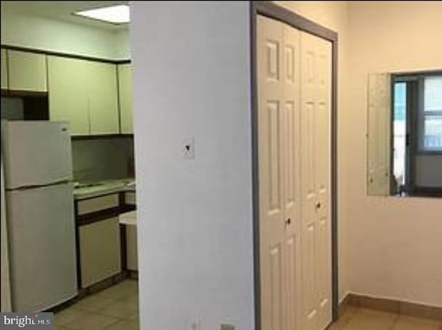 corridor with light tile patterned floors