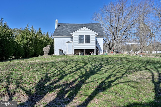 back of property featuring a yard