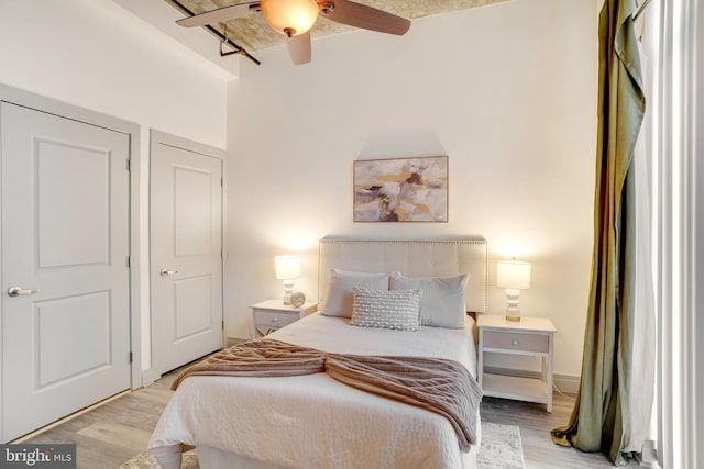 bedroom with ceiling fan and light hardwood / wood-style floors