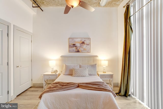 bedroom with ceiling fan and light wood-type flooring