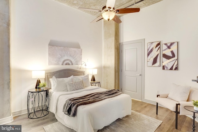 bedroom featuring ceiling fan and light hardwood / wood-style flooring