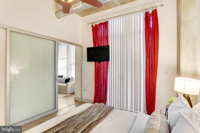 bedroom featuring ceiling fan, a closet, and hardwood / wood-style floors