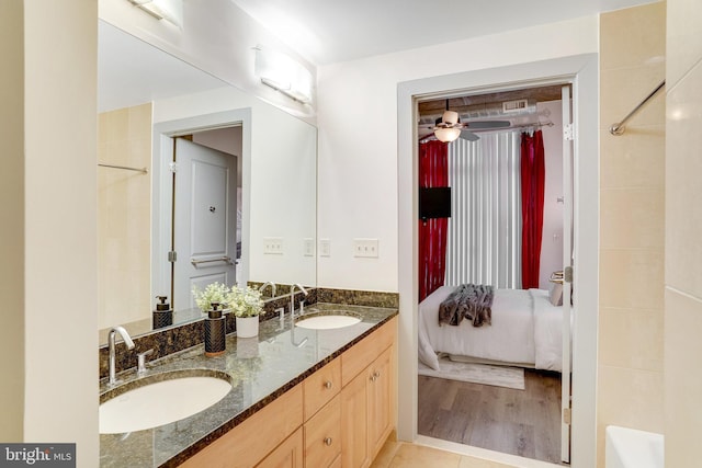 bathroom featuring ceiling fan, vanity, and tile patterned floors