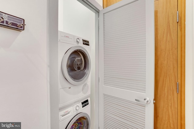 washroom featuring stacked washer / drying machine