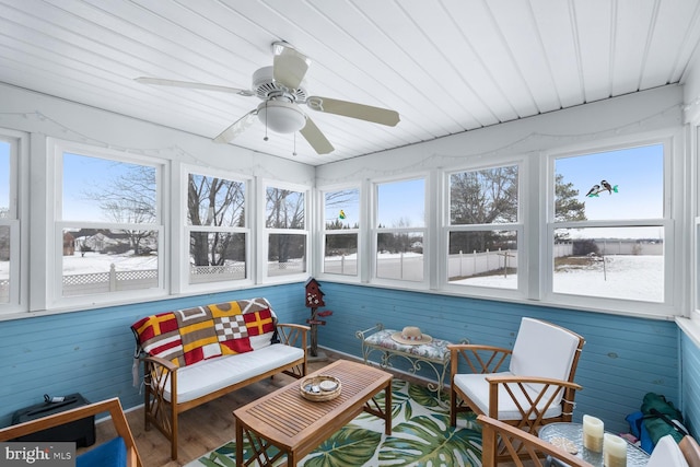 sunroom / solarium featuring ceiling fan