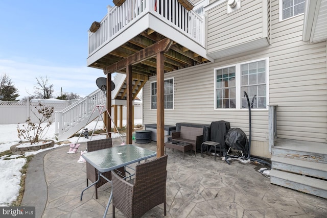 snow covered patio with an outdoor living space