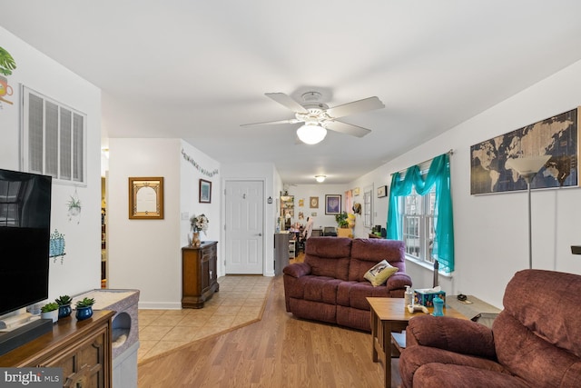 living room with ceiling fan and light hardwood / wood-style floors