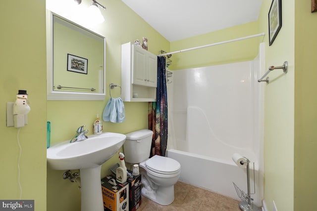 bathroom featuring tile patterned flooring, shower / bath combo with shower curtain, and toilet