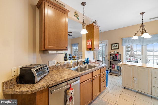 kitchen with decorative light fixtures, dishwasher, sink, and light tile patterned floors