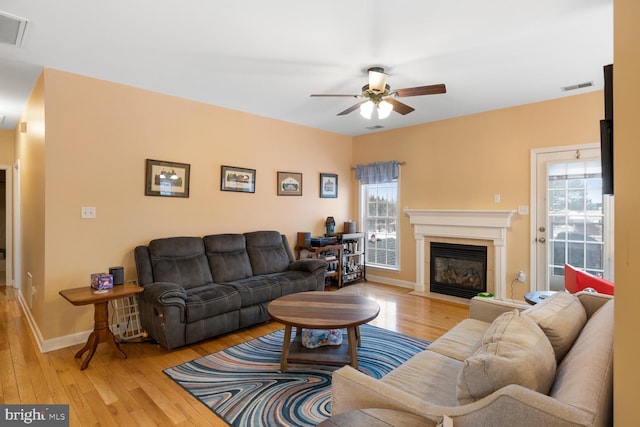 living room featuring ceiling fan and light wood-type flooring