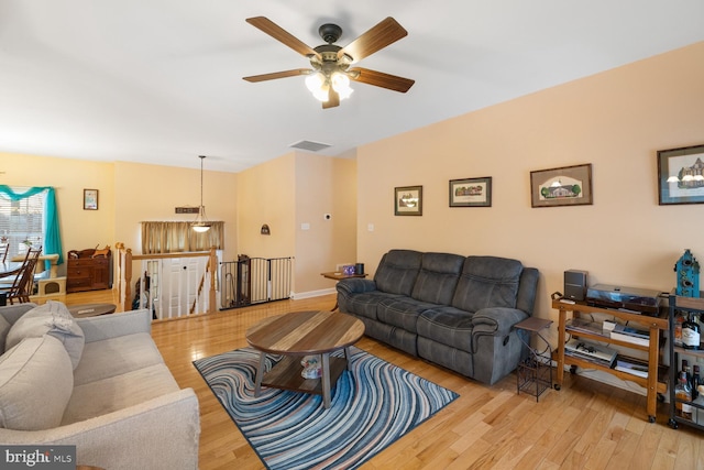 living room featuring ceiling fan and light hardwood / wood-style floors