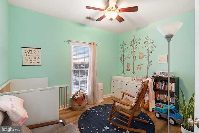 bedroom featuring hardwood / wood-style flooring and ceiling fan