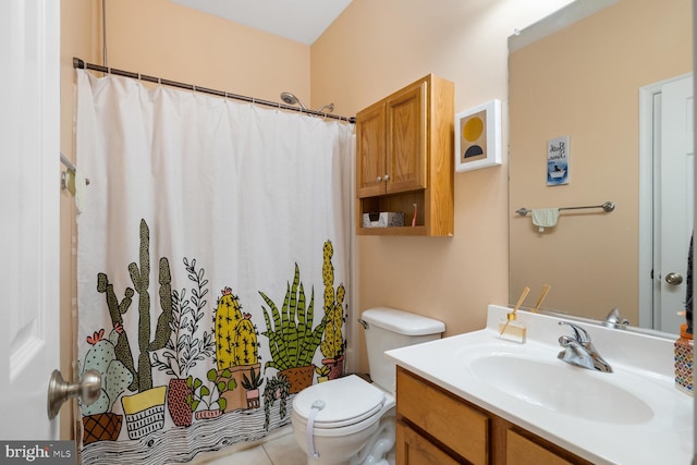 bathroom with tile patterned floors, vanity, toilet, and curtained shower