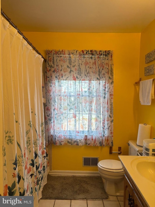 bathroom with vanity, tile patterned floors, and toilet