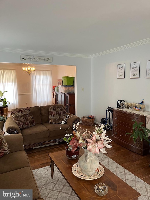 living room with crown molding, light hardwood / wood-style flooring, and a chandelier