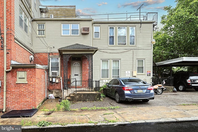multi unit property with brick siding and cooling unit