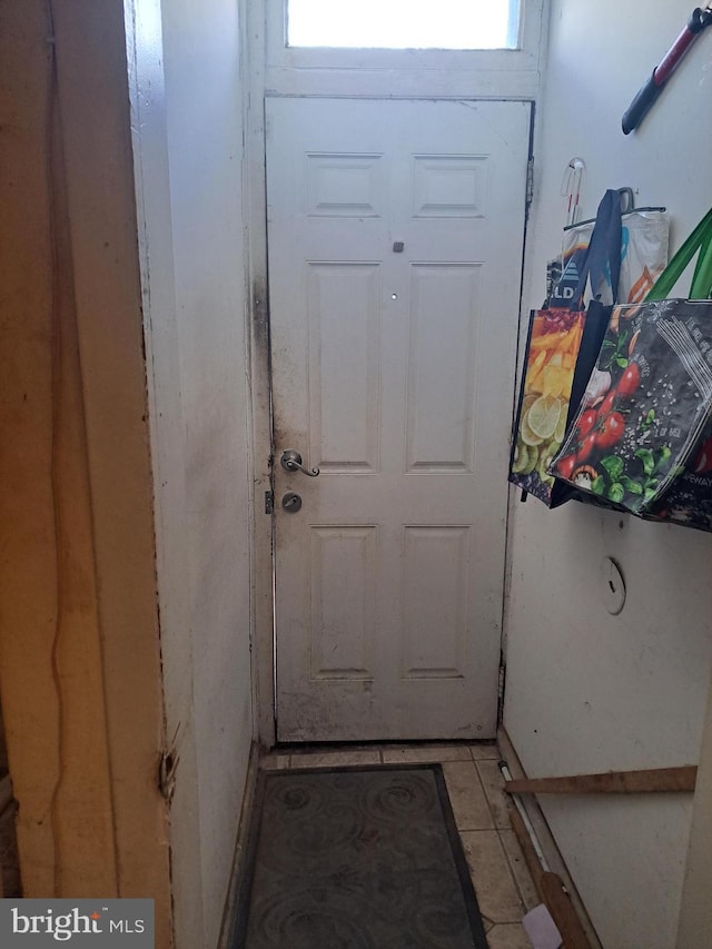 doorway with light tile patterned floors