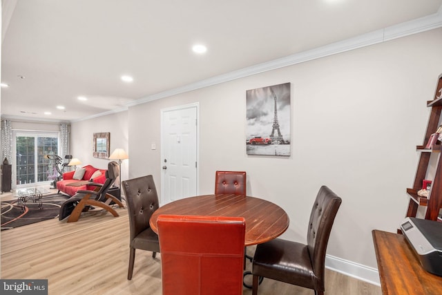 dining room featuring wood-type flooring and ornamental molding