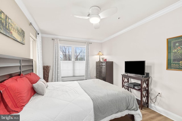 bedroom with ceiling fan, wood-type flooring, and ornamental molding