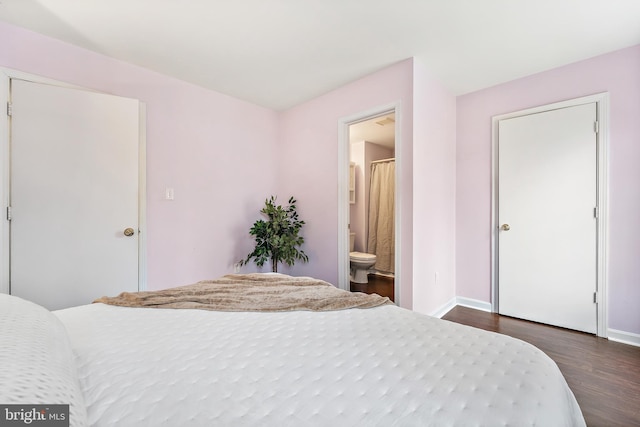 bedroom featuring dark wood-type flooring and connected bathroom