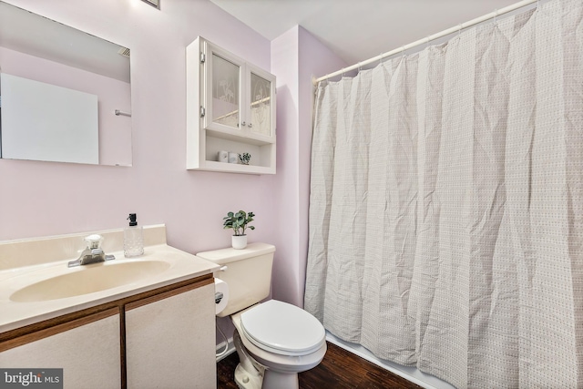 bathroom featuring vanity, toilet, and hardwood / wood-style floors