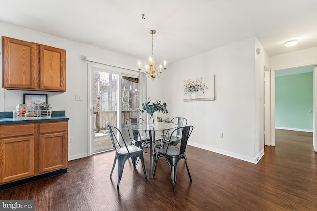 dining area featuring dark hardwood / wood-style floors and a chandelier