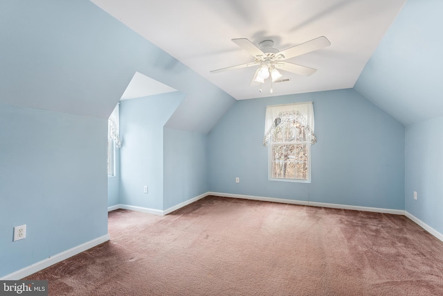 additional living space featuring lofted ceiling, ceiling fan, and carpet