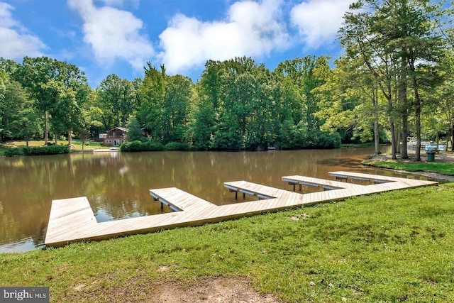 dock area featuring a water view and a lawn