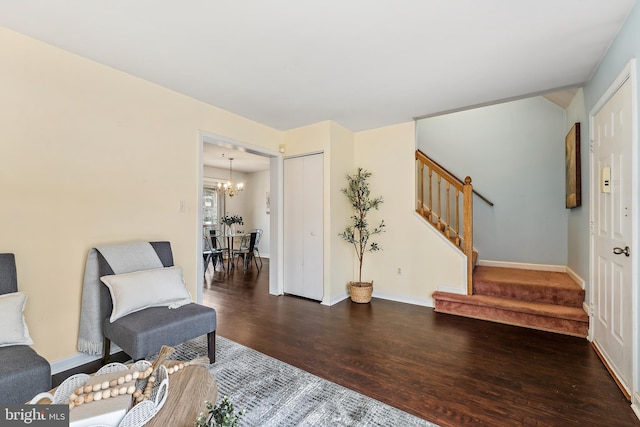 living area featuring dark hardwood / wood-style flooring and a notable chandelier