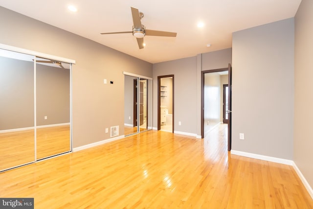 unfurnished bedroom with ceiling fan and wood-type flooring