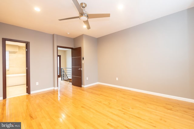 unfurnished bedroom with ceiling fan, connected bathroom, and hardwood / wood-style flooring