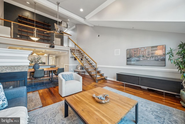 living room featuring hardwood / wood-style floors and a towering ceiling