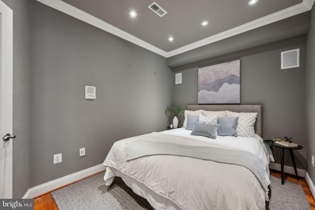 bedroom featuring wood-type flooring and crown molding