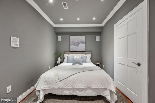 bedroom with hardwood / wood-style floors and ornamental molding