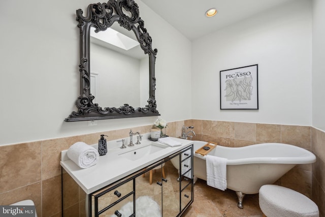 bathroom with sink, a bathtub, and tile walls