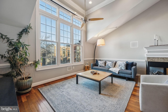 living room with hardwood / wood-style floors, a healthy amount of sunlight, ceiling fan, and ornamental molding