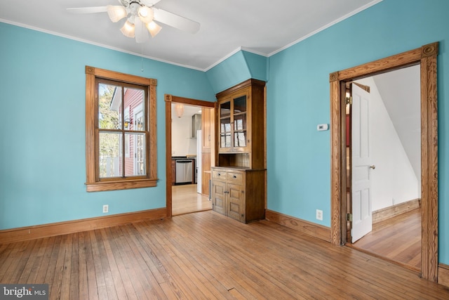 unfurnished room featuring ceiling fan, ornamental molding, and light hardwood / wood-style floors