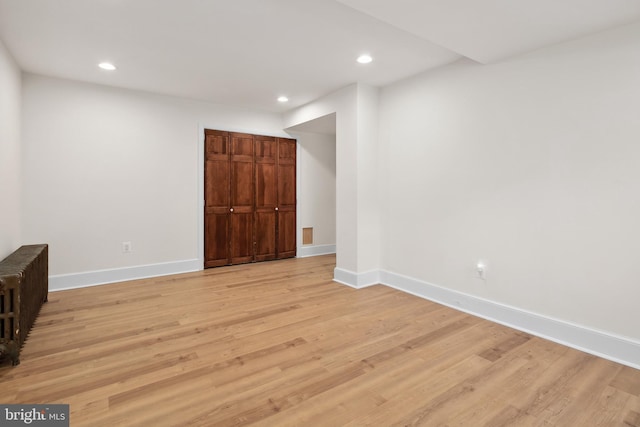 interior space featuring light wood-type flooring and radiator heating unit