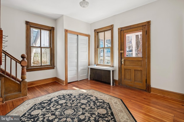 foyer featuring radiator and hardwood / wood-style floors