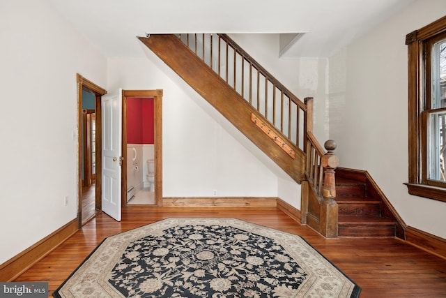 stairs with hardwood / wood-style flooring